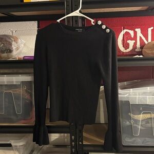 Black long sleeve top with flower detail on shoulder from Vici